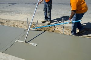 Workers laying concrete for a foundation in Garland