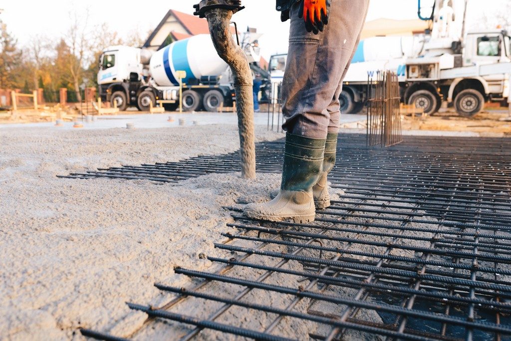 Concrete worker laying a foundation for a business in Garland